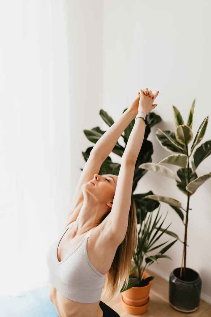 flexible sportswoman doing yoga exercise at home